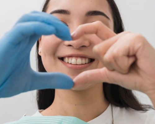 dentist-forming-heart-shape-with-hands_23-2148104999